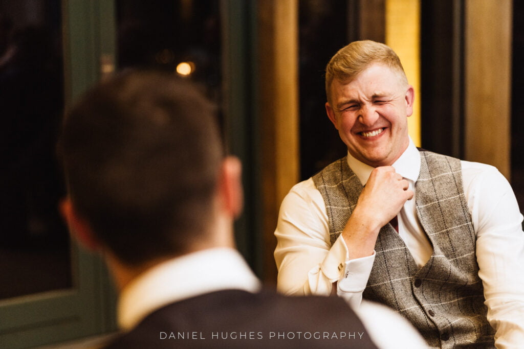 Guest laughing at speeches at Hazel Gap Barn by Nottingham Wedding Photographer Dan Hughes