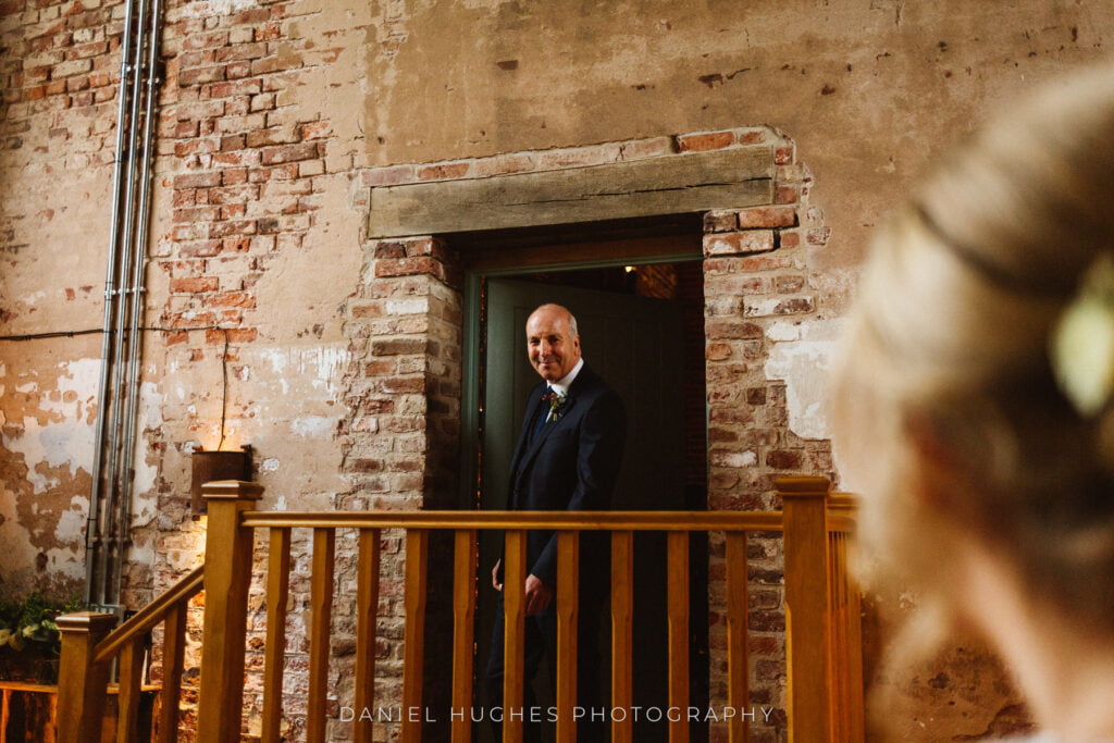 The first look, Dad coming through a doorway in the back room of the main barn, with the bride's head  out of focus in the foreground.