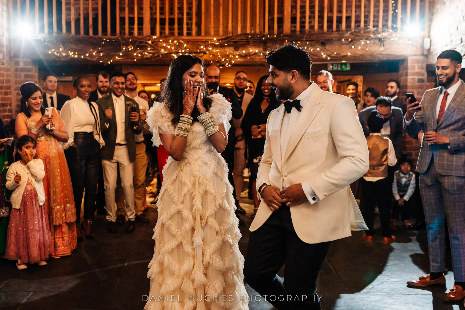 Gurpreet is serenading Kamrun during their first dance at Curradine Barns. Kamrun is holding her face in wondrous shock!